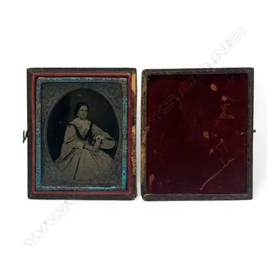 Silver framed and matted leather cased ambrotype - seated woman in striped dress,